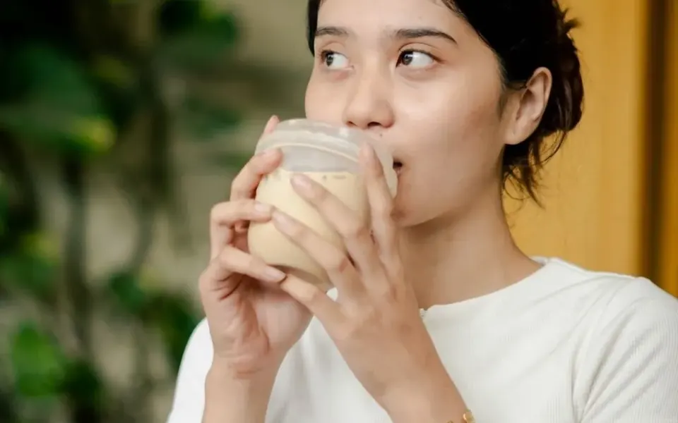 Photo content for Kissa Coffee: a woman enjoying a coffee drink